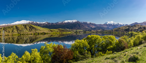 Lake Hayes reflecting Coronet  mountains, near Queenstown, New Zealand photo