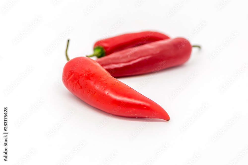 Red Chillies against a White Background, with a Shallow Depth of Field Red Chillies against a White Background, with a Shallow Depth of Field