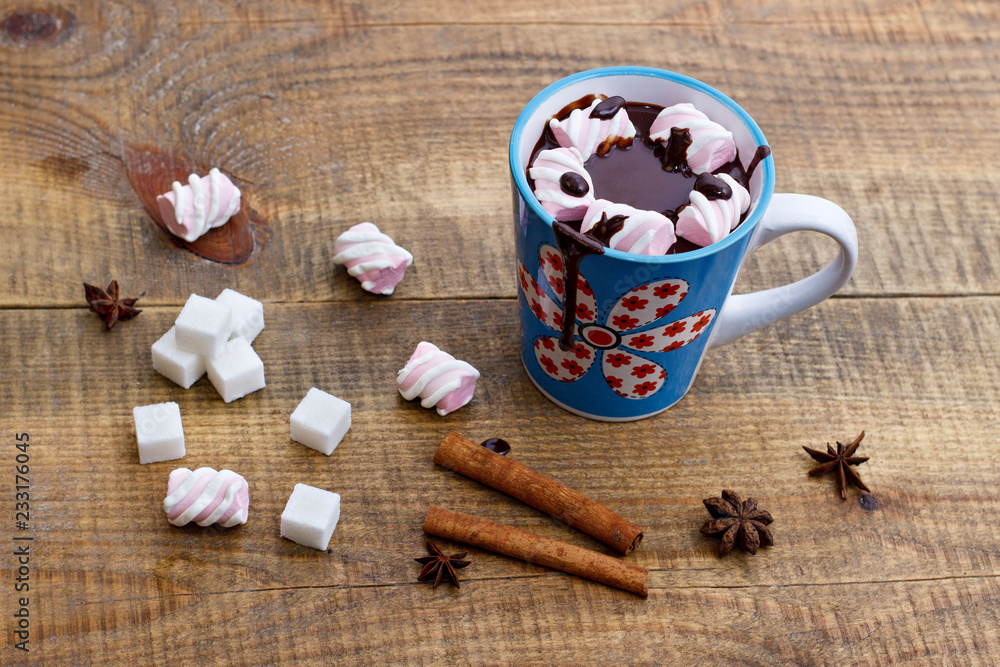 Hot chocolate with spices and marshmallows on a wooden background. New Year Christmas Hot chocolate with spices and marshmallows on a wooden background. New Year Christmas