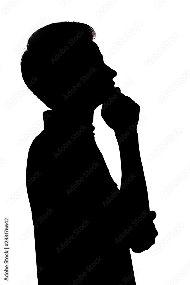 black and white silhouette of an guy thoughtfully looking up,young man face profile