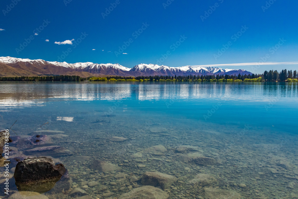Lake Ruataniwha, New Zealand, South Island, trees and mountains, azure water reflections
