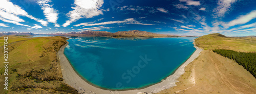 Fototapeta Naklejka Na Ścianę i Meble -  Aerial drone shots of Lake Tekapo with reflection of sky and mountains, New Zealand