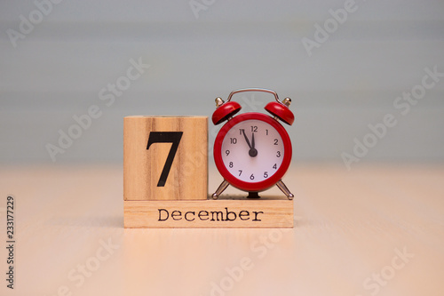 Wallpaper Mural December 7th set on wooden calendar and red alarm clock with blue background. Torontodigital.ca