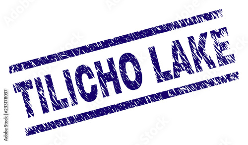 TILICHO LAKE seal print with distress style. Blue vector rubber print of TILICHO LAKE title with grunge texture. Text title is placed between parallel lines.