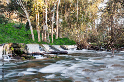 Small waterfall in a forest river photo