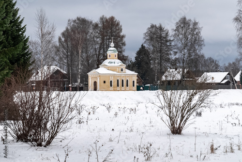 Russian Winter. Historical and tourist places in Russia. View of the Church of All Saints in Tikhvin on the bank of the Tikhvinka River.