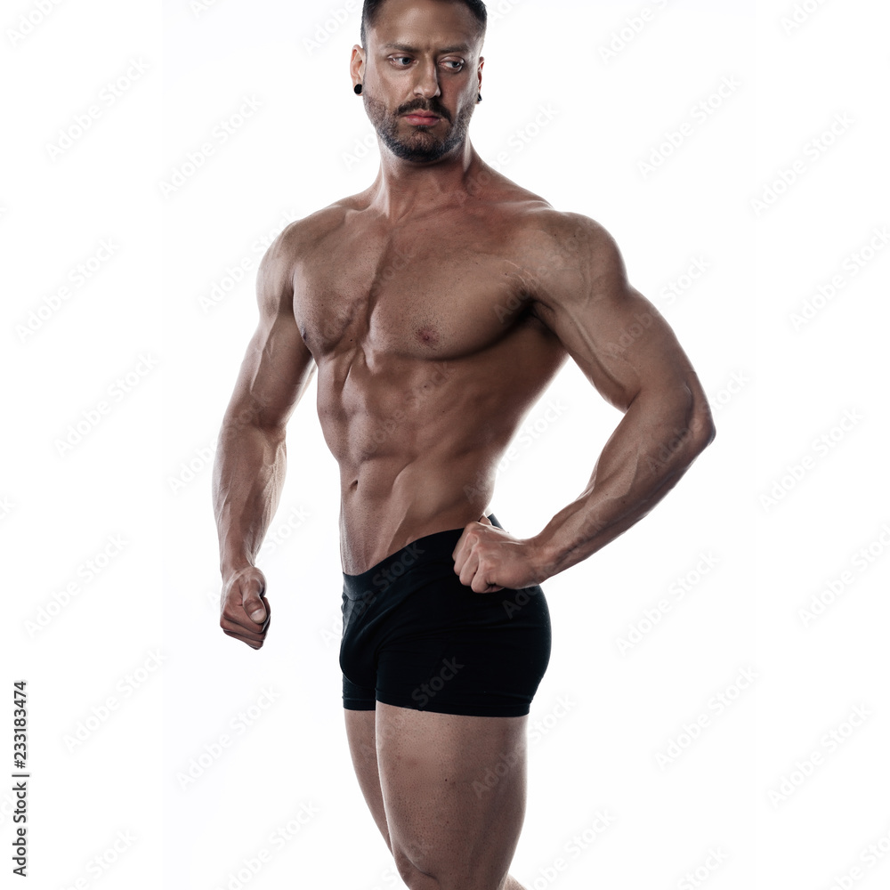 Brutal strong bodybuilder athletic man posing on white background. Brutal strong bodybuilder athletic man posing on white background.