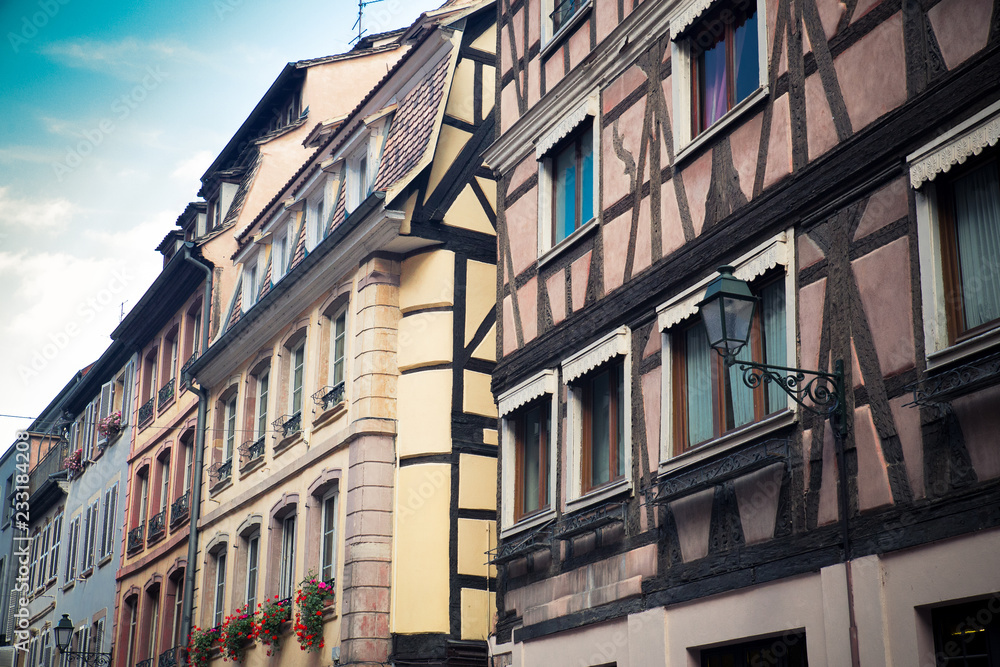 Obraz premium Row of traditional old European buildings with half-timbered construction and window shutters from Strasbourg France.