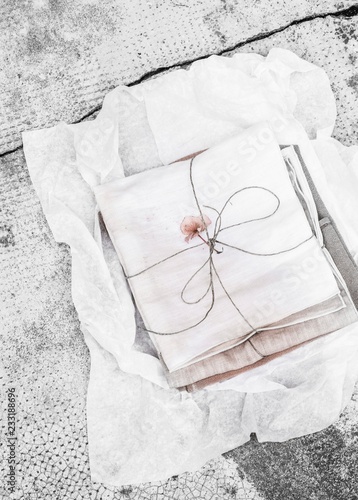 Tied bundles of hand-dyed fabrics on white tissue paper