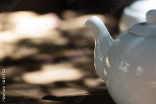 white teapot on a blurred background photo