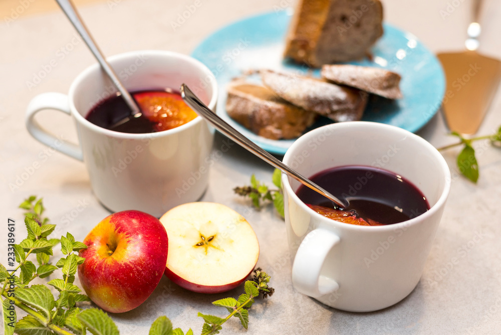 Hot mulled red wine with traditional Czech cake called babovka, on the concrete table Hot mulled red wine with traditional Czech cake called babovka, on the concrete table