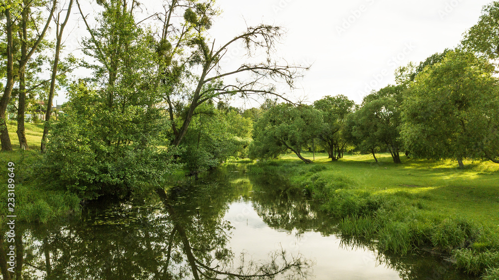 Small lake with reflection of trees in the water Small lake with reflection of trees in the water