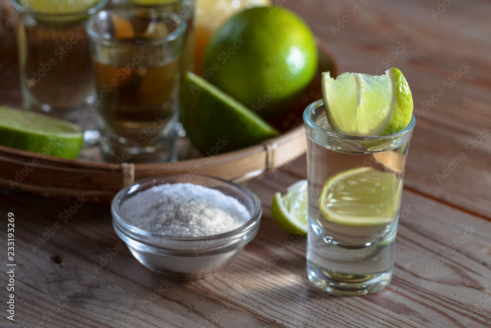 Tequila and lime slices. Tequila and lime slices.