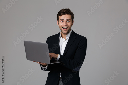 Portrait of a happy young businessman dressed in suit