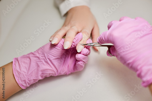 Manicurist remove the cuticle of a girl in a beauty salon © Semenova Jenny