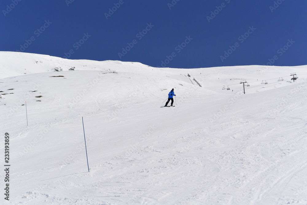 Skiers goes down of the snowy mountains of Sierra Nevada