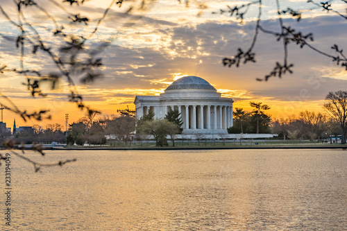 Thomas Jefferson Memorial with water, park, and sunset or sunrise in Washington DC