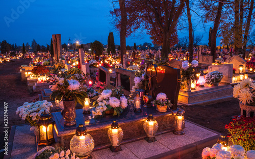 Bild auf Leinwand Candles Burning At a Cemetery During All Saints Day.