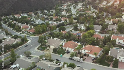 The Sunset over a residential area in between green mountiains in Southern California
