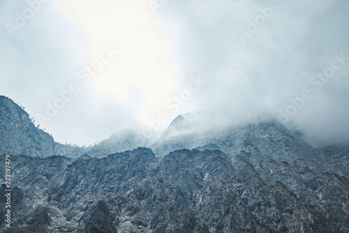Dramatic Mountain Range With Stormy Clouds In The Sky - Blue Color