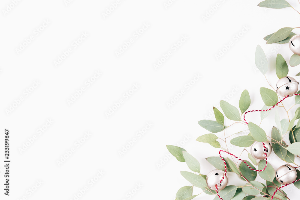 Minimal christmas composition. X-mas card. New Year card. Winter holiday composition with eucalyptus and christmas balls on wooden white background. Flat lay, top view, copy space