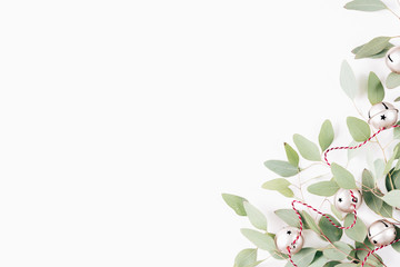 Minimal christmas composition. X-mas card. New Year card. Winter holiday composition with eucalyptus and christmas balls on wooden white background. Flat lay, top view, copy space