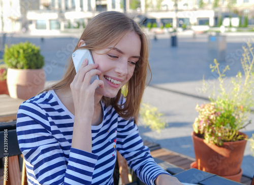 Beautiful girl talking on the phone and smiling