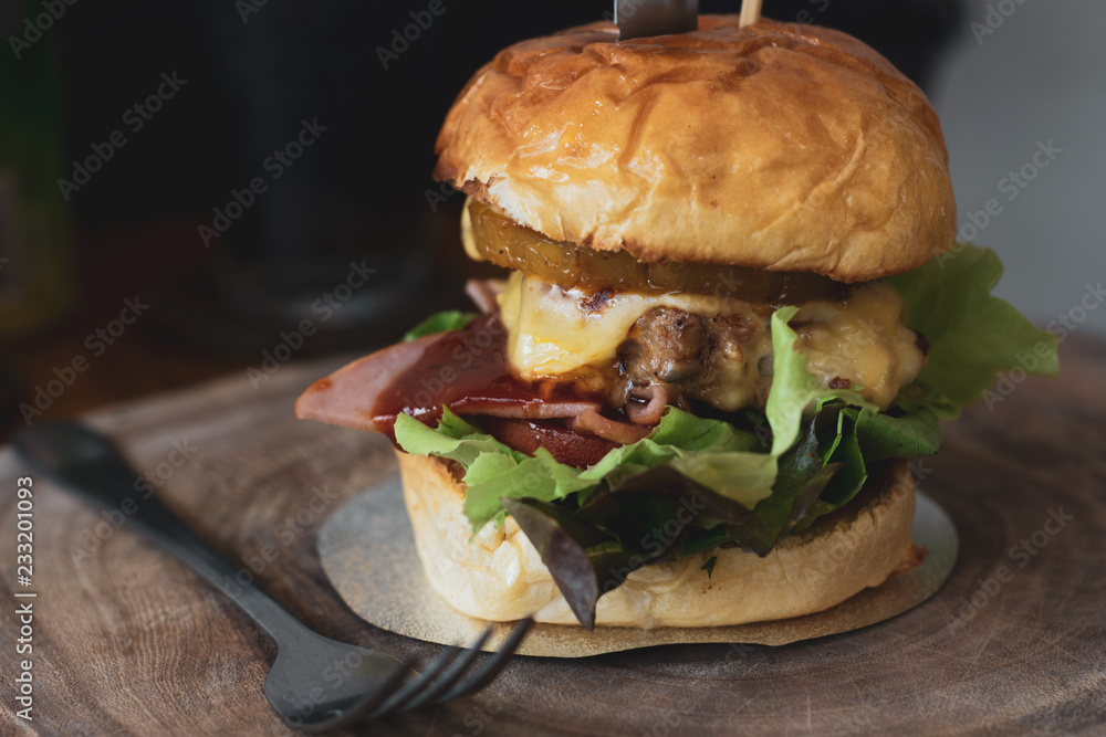 Hamburger on wooden cutting board. Hamburger on wooden cutting board.
