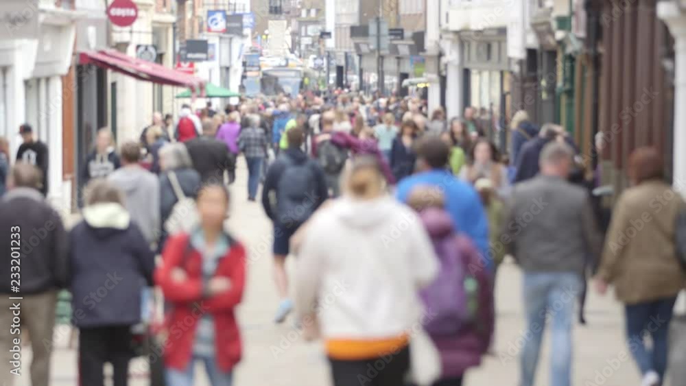 A defocussed shot of crowds of unidentifiable people with faces blurred walking on a busy British high street A defocussed shot of crowds of unidentifiable people with faces blurred walking on a busy British high street