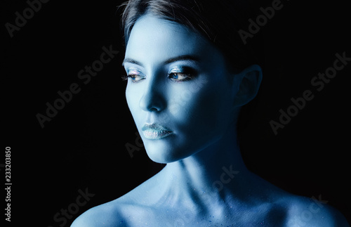 Portrait of a young woman model with blue make-up.