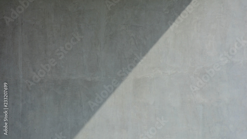 Gray concrete wall with shadow from building - background