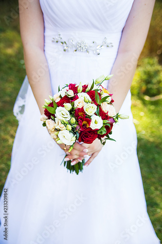 bride in white dress holding a bouquet.