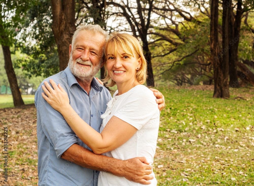 Happy senior couple together in a summer park, Being together and staying strong, happy life. Happy senior couple together in a summer park, Being together and staying strong, happy life.