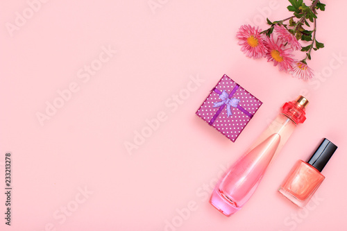 Gift box, perfume and cosmetics on a pink background
