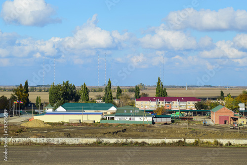 A view from above of a small Russian village. Rural landscape. Field and village. A semi-abandoned village photo