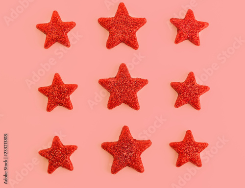 Nine red stars on pink background. Flat lay. View from above