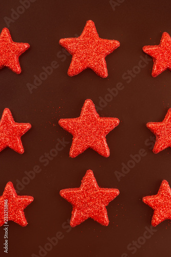 Nine red stars on black background. Flat lay. View from above