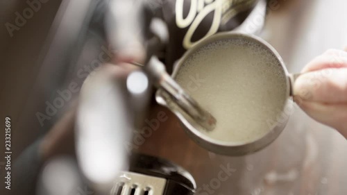 Female Barista Steaming a Mug of Hot Milk for a Latte. Espresso Coffee Preparation in Super Slow Motion