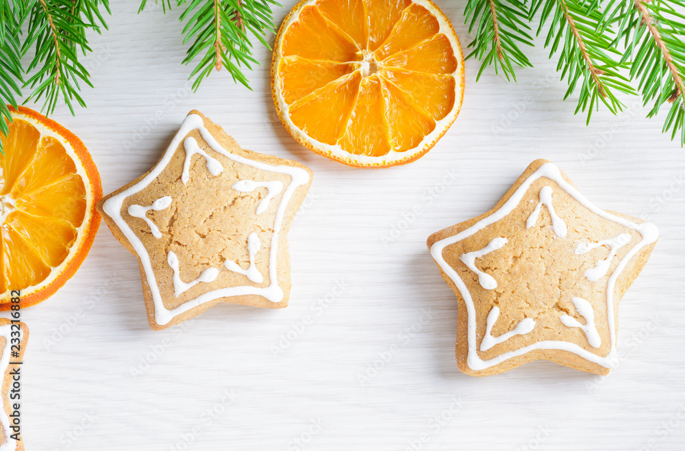 Gingerbreads and Christmas tree branches on wooden background Gingerbreads and Christmas tree branches on wooden background