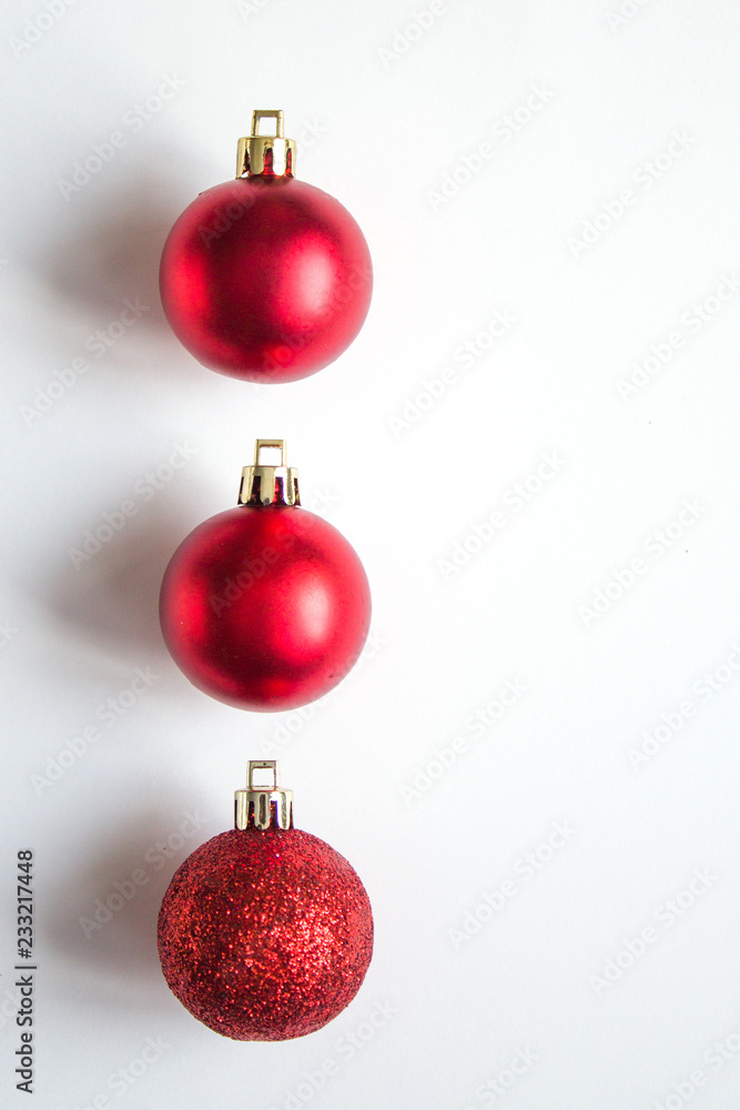 three red balls with shadow for a Christmas tree in a row on a white background. copy space three red balls with shadow for a Christmas tree in a row on a white background. copy space