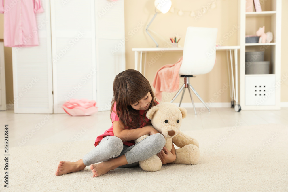 Cute little girl playing with teddy bear at home Cute little girl playing with teddy bear at home