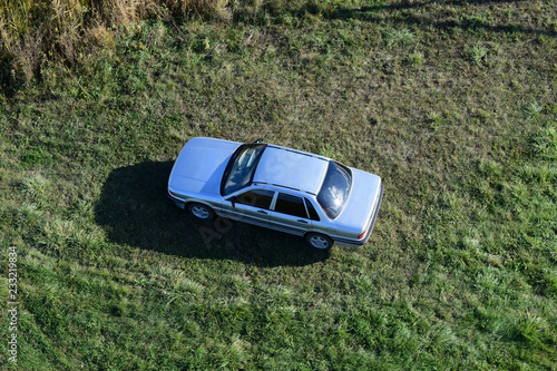 Top view of a silver car standing on the lawn. One Flew Over the Car