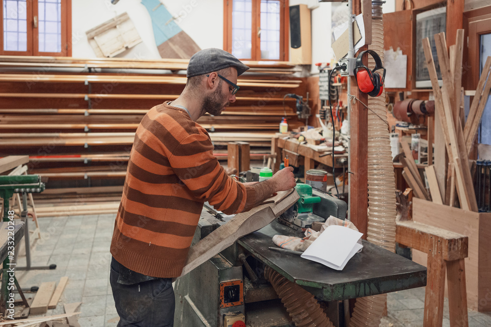Carpenter marking the detail in workshop Carpenter marking the detail in workshop