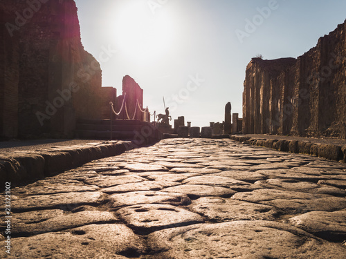 Beautiful view of the ancient city of Pompeii on the background of the sunset rays. Concept of travel