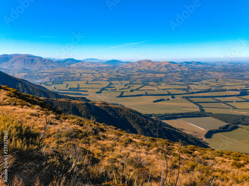 view over Mount Hutt mountainous landscape on a sunny day, near Methven, South Island, New Zealand photo