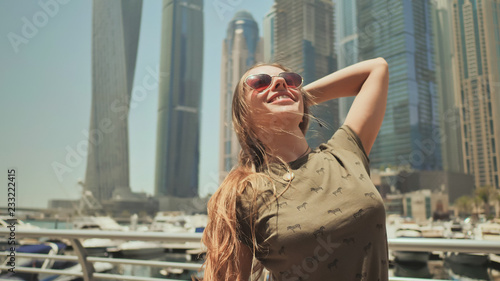 Photography A happy girl is in Dubai on a background of skyscrapers Dubai Marina