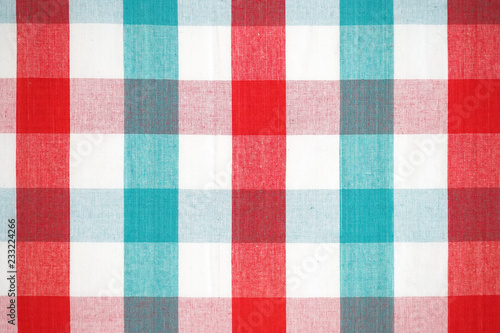 Close up texture of Christmas red and green plaid pattern, checkered fabric of picnic mat in Christmas color gingham background.