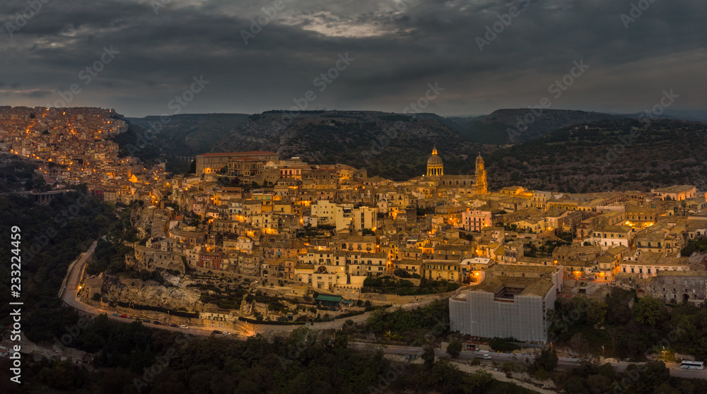 Aerial panorama of Ragusa Ibla and Ragusa Superiore or Upper town - a part of a UNESCO World Heritage Site. Night lights of the city of Ragusa, Sicily. Cathedral of San Giorgio built in baroque style