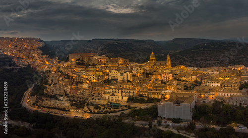 Aerial panorama of Ragusa Ibla and Ragusa Superiore or Upper town - a part of a UNESCO World Heritage Site. Night lights of the city of Ragusa, Sicily. Cathedral of San Giorgio built in baroque style