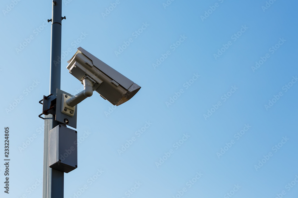 Security camera on blue sky background. Security view post Security camera on blue sky background. Security view post
